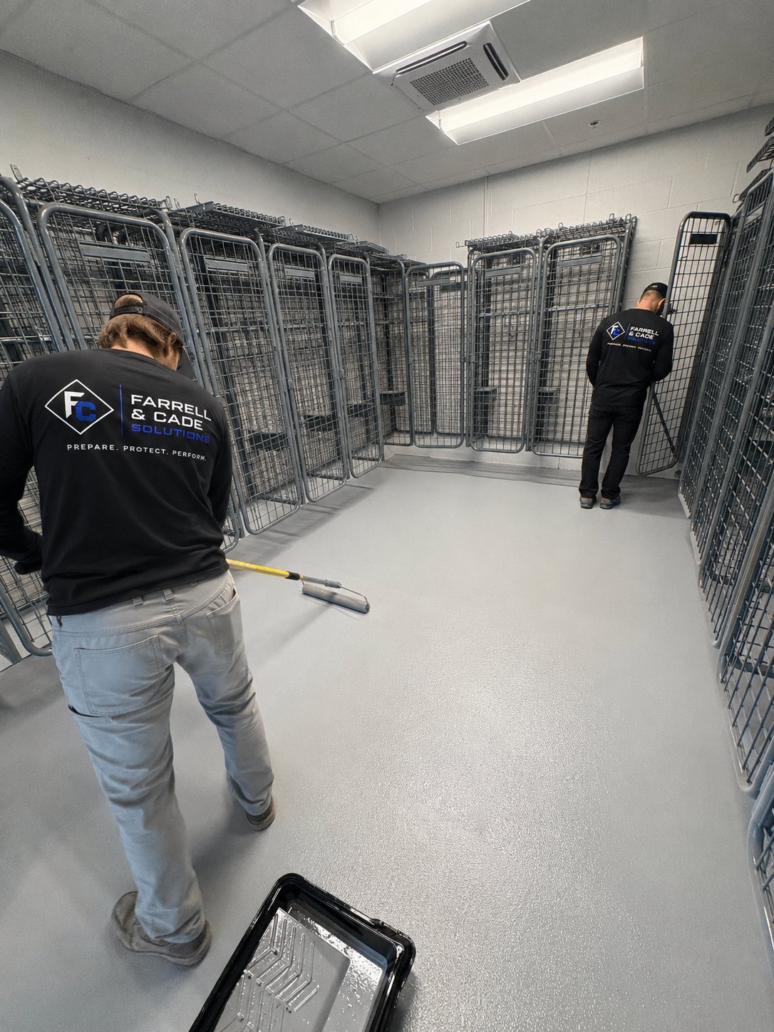 Farrell & Cade crew installing kennel coating system