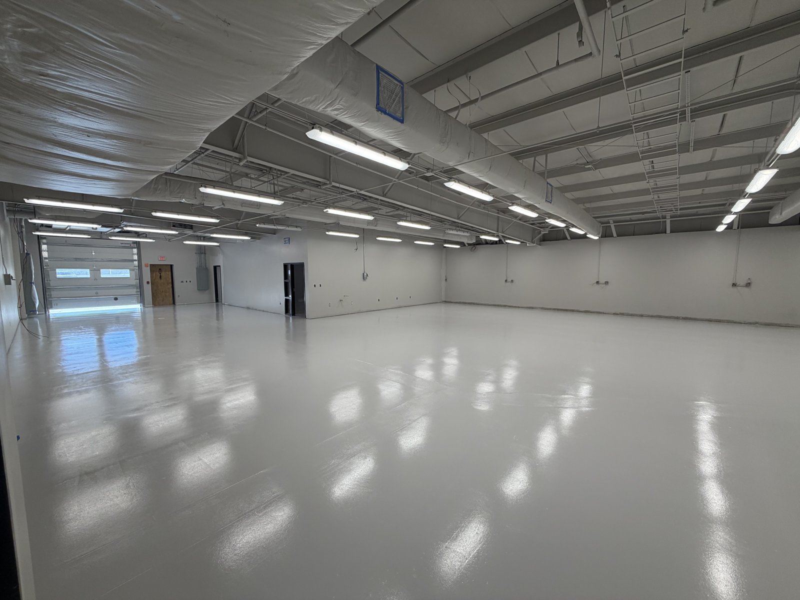 Distribution facility with light gray epoxy and roll-up door